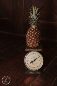farm fresh fruit, fruit on a scale, pineapple, pineapple being weighed, balancing light on objects